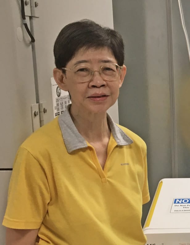 A person with glasses and a yellow top
