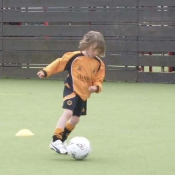 Kai playing football when he was younger