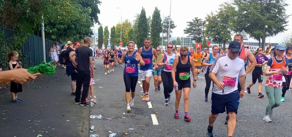 Millie runs in a crowd of people at the Great North Run