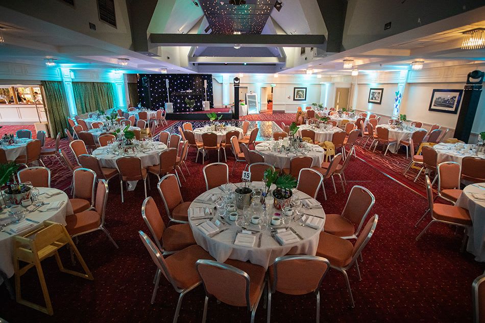 A photo showing chairs, tables and lights set up for the evening reception at the DEBRA UK Members