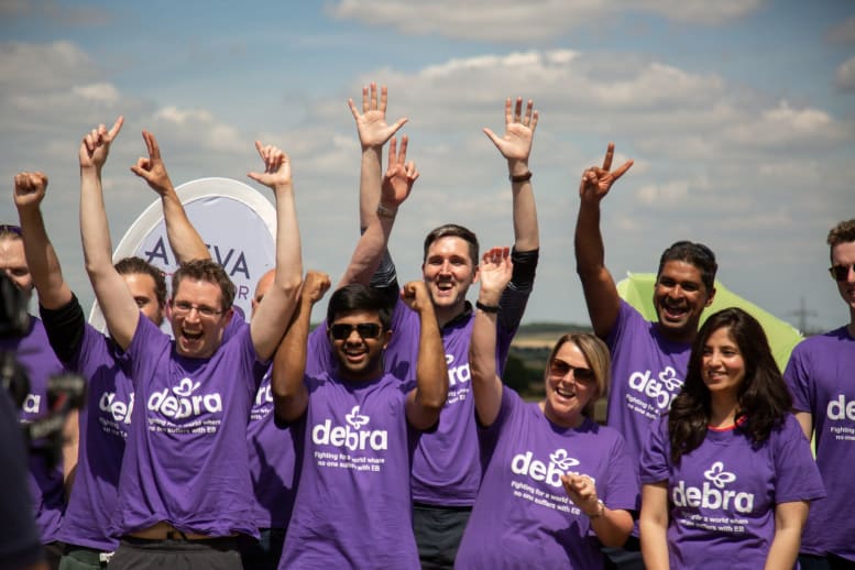 AVEVA team raising their hands in the air wearing DEBRA t shirts