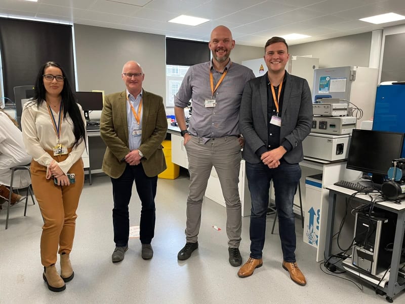 Four members of the EB research team from Birmingham university standing in a lab