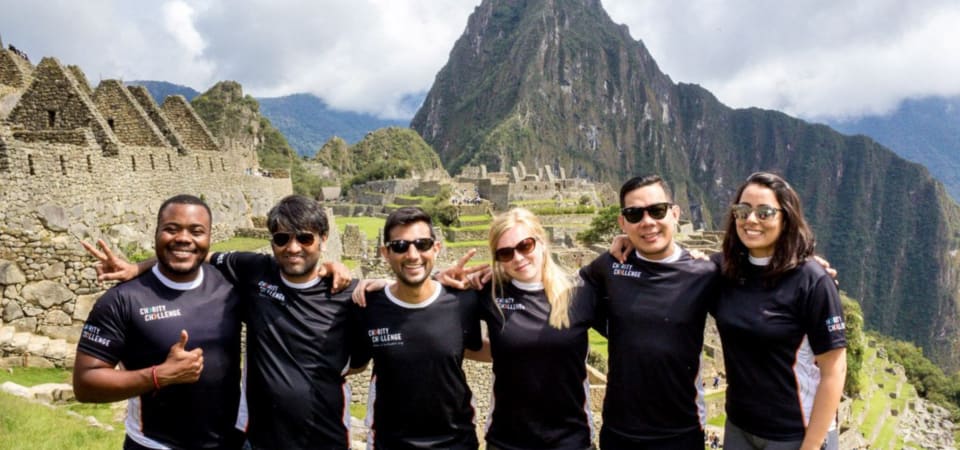 Group wearing charity challenge t shirts at the site of Machu Picchu