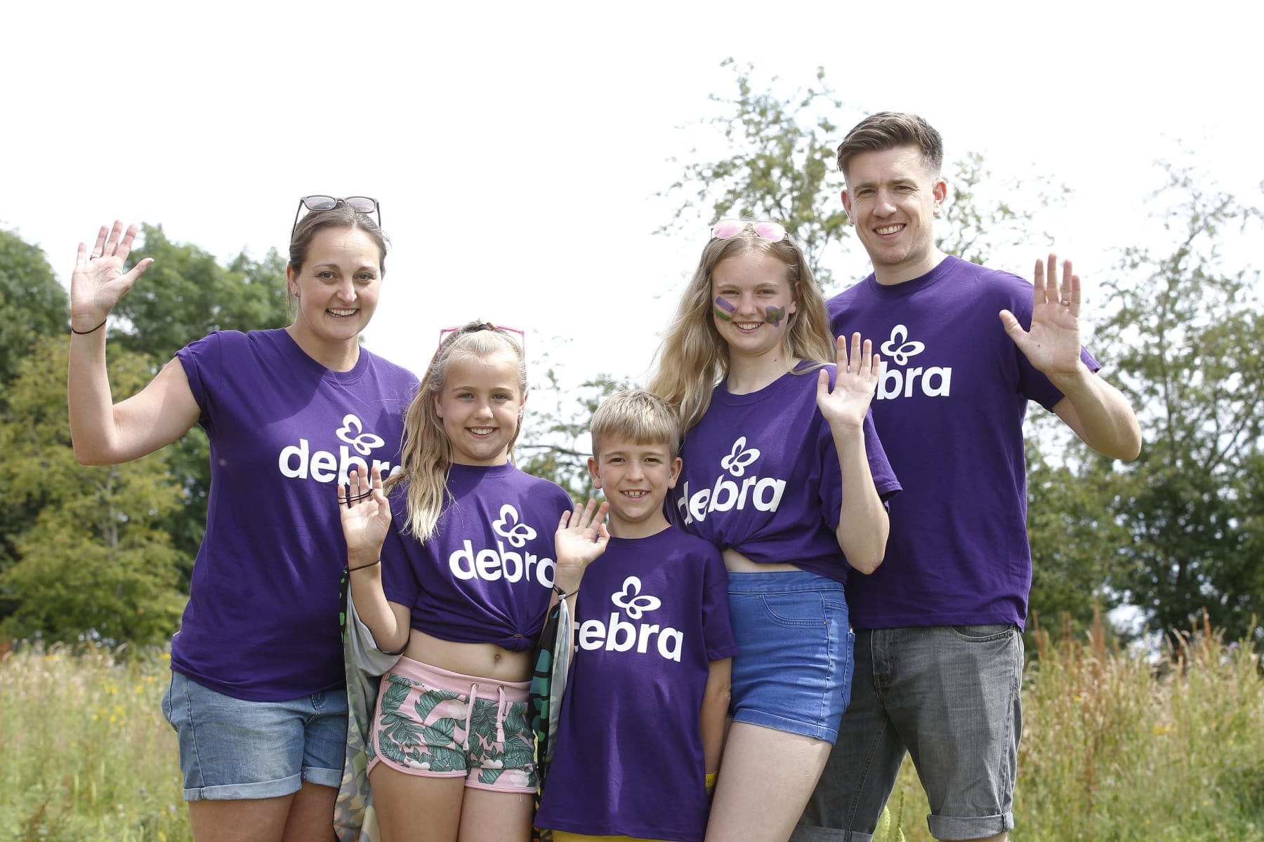 Family wearing DEBRA t-shirts