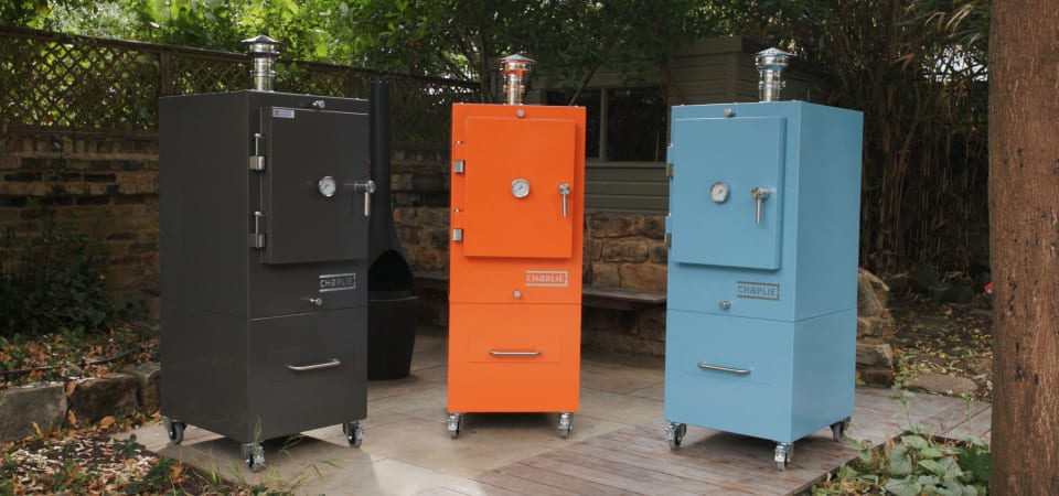 3 Charlie outdoor ovens in black, orange and blue.