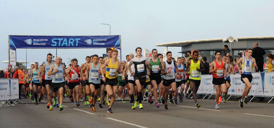Runners cross the start line of the Manchester half marathon