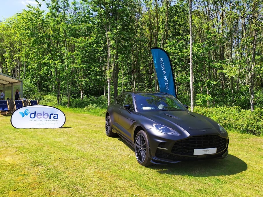 Matte black Aston Martin car parked outside the Pavillion at DEBRA EJ Churchill event